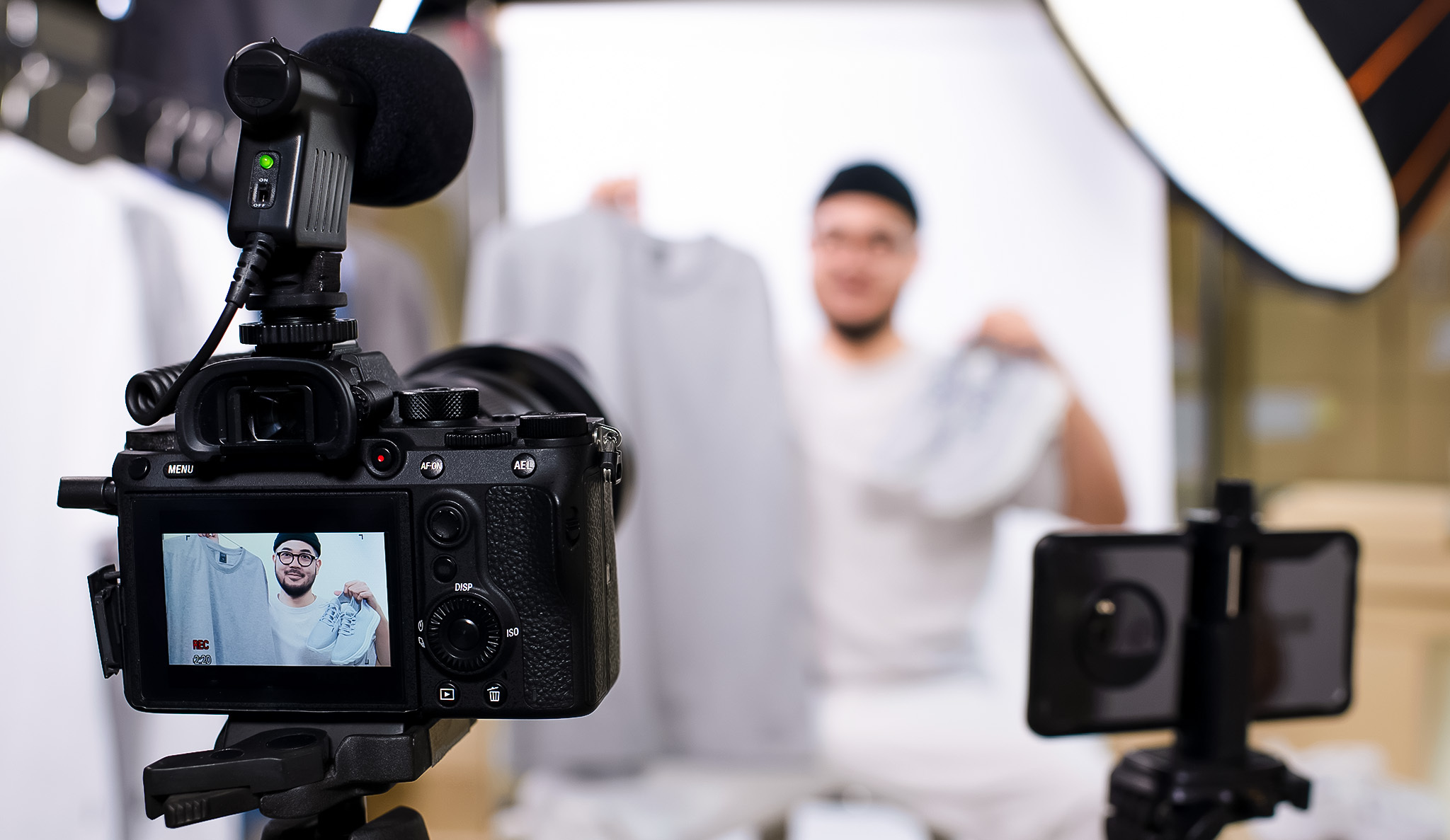 Camera filming a person in the background.